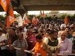 BJP supporters hold party flags outside a counting centre in Jammu on Tuesday. (AP) BJP supporters hold party flags outside a counting centre in Jammu on Tuesday. (AP)