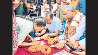 BJP state unit chief Babulal Marandi hit the streets on Tuesday and had forms for the scheme filled out by women. (HT Photo) BJP state unit chief Babulal Marandi hit the streets on Tuesday and had forms for the scheme filled out by women. (HT Photo)