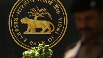 RBI MPC: A police officer walks past the Reserve Bank of India (RBI) logo inside its headquarters in Mumbai, India. (Reuters)
