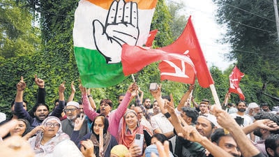 Supporters of the Congress and National Conference celebrate outside a counting centre on the outskirts of Srinagar on Tuesday. (AP) Supporters of the Congress and National Conference celebrate outside a counting centre on the outskirts of Srinagar on Tuesday. (AP)