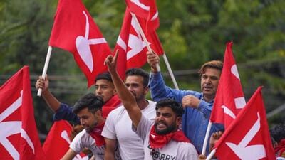 Supporters of the National Conference party celebrate after the assembly election results in Srinagar on Tuesday. (AP)