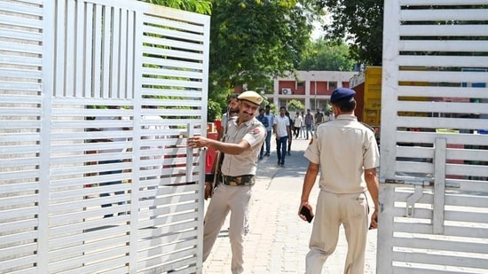 Security personnel guard outside the EVM strong room at the Government Girls College in Sector 14 counting centre on Sunday. (Parveen Kumar/HT Photo)