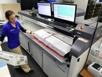 A worker processes mail-in ballots for the state's primary elections at the Orange County Supervisor of Elections office in Orlando, Fla., March 17, 2020. (Joe Burbank/Orlando Sentinel via AP, File)