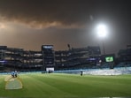 Ground staff cover the field after rain delayed a match at Arun Jaitley Stadium in Delhi