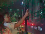 In the clip, recorded at a traffic signal in Maharashtra, a man and a woman are seen on a bike next to a police van. 