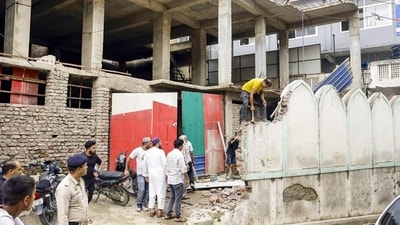An alleged illegal portion of a mosque was demolished by the mosque management on the order of municipal commissioner in Mandi. (PTI) An alleged illegal portion of a mosque was demolished by the mosque management on the order of municipal commissioner in Mandi. (PTI)