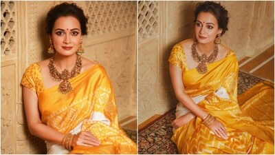 Dia looks elegant in this yellow and white silk saree featuring gorgeous traditional patterns. The actor posted the photos with the caption, "Shubho Mahalaya." The white and yellow colours are considered auspicious in Hindu culture, making the drape a perfect pick for the festive season. Dia wore it with a matching silk blouse and gold temple jewellery.&nbsp; 