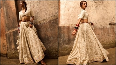Triptii Dimri's edgy look is for girls who love mixing modern and traditional elements. She wears a white ribbed crop blouse featuring a plunging neckline, a backless design with dori ties, and half-length sleeves. She paired the choli with a printed lehenga cinched with a tan belt.&nbsp; 