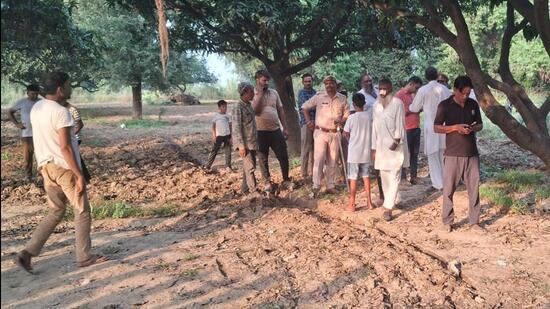 Villagers gather at the spot where four people were injured on Wednesday morning in Arifpur Badka village near Masuri. (Sakib Ali/HT Photo)