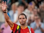 Rafael Nadal reacts waves after the men's doubles quarter-final tennis competition at the Roland Garros stadium