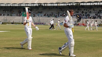 England's Harry Brook walks off for lunch with Joe Root (REUTERS)