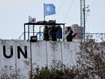 Members of the United Nations peacekeepers (UNIFIL) look at the Lebanese-Israeli border, as they stand on the roof of a watch tower ‏in the town of Marwahin, in southern Lebanon.