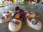 An artist prepares effigies of the demon king Ravana for the Dussehra festival celebration.