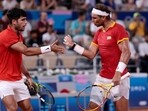 Carlos Alcaraz and Rafael Nadal react during a match at the Paris Olympics.