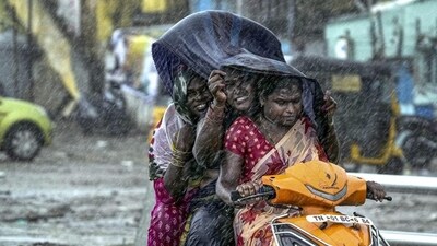 Commuters during heavy rain in Chennai. (PTI) Commuters during heavy rain in Chennai. (PTI)