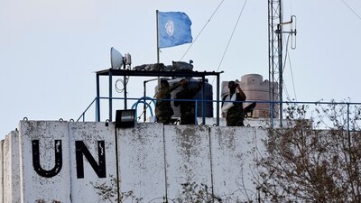 Members of the United Nations peacekeepers (UNIFIL) look at the Lebanese-Israeli border, as they stand on the roof of a watch tower ‏in the town of Marwahin, in southern Lebanon. (Reuters / File)