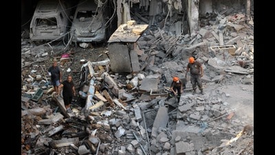 Lebanese civil defence work at the site of an Israeli air strike in the Basta area, in Beirut, on October 11, 2024, amid the ongoing war between Israel and Hezbollah. An Israeli air strike killed at least 22 people in central Beirut on October 10, as Israeli ground troops in Lebanon were accused of firing on the UN's peacekeeping headquarters, injuring two Blue Helmets. (Photo by ANWAR AMRO / AFP) (AFP) Lebanese civil defence work at the site of an Israeli air strike in the Basta area, in Beirut, on October 11, 2024, amid the ongoing war between Israel and Hezbollah. An Israeli air strike killed at least 22 people in central Beirut on October 10, as Israeli ground troops in Lebanon were accused of firing on the UN's peacekeeping headquarters, injuring two Blue Helmets. (Photo by ANWAR AMRO / AFP) (AFP)
