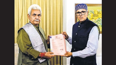Omar Abdullah hands letters of support to J&K LG Manoj Sinha at Raj Bhawan in Srinagar on Friday. (PTI) Omar Abdullah hands letters of support to J&K LG Manoj Sinha at Raj Bhawan in Srinagar on Friday. (PTI)