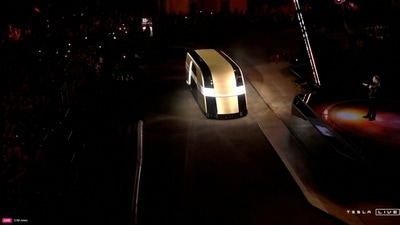 Tesla's CEO Elon Musk introduced the Cybercab robotaxi and Robovan concepts, aiming for production in 2026. The Cybercab may cost less than $30,000. (Reuters)