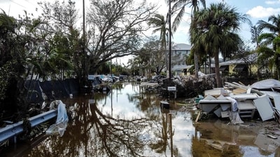 TOPSHOT - A flooded street with debris in the aftermath of Hurricane Milton, in Siesta Key, Florida, on October 10, 2024. At least 10 people were dead after Hurricane Milton smashed into Florida. (AFP) TOPSHOT - A flooded street with debris in the aftermath of Hurricane Milton, in Siesta Key, Florida, on October 10, 2024. At least 10 people were dead after Hurricane Milton smashed into Florida. (AFP)