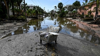 A flooded street with debris in the aftermath of Hurricane Milton, in Siesta Key, Florida, on October 10, 2024 after the monster weather system sent tornados spinning across the state and flooded swaths of the Tampa Bay area. (Photo by CHANDAN KHANNA / AFP) (AFP)