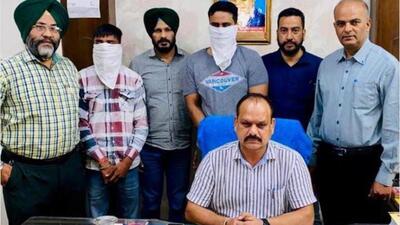 Vigilance Bureau officials with the Phagwara city police station SHO Jatinder Kumar (fourth from left, face covered) and his accomplice, Jaskaran Singh (second from left), in Jalandhar on Friday. (HT Photo) Vigilance Bureau officials with the Phagwara city police station SHO Jatinder Kumar (fourth from left, face covered) and his accomplice, Jaskaran Singh (second from left), in Jalandhar on Friday. (HT Photo)