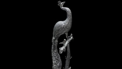 Prime Minister Narendra Modi gifts a Silver Nakkashi work peacock figurine to PM of Japan, Shigeru Ishiba, in Vientiane on Friday. This exquisite silver peacock sculpture has been adorned with intricate nakkashi (carving) work, originating from West Bengal, India. The craftsmanship is a hallmark of traditional metal artistry, combining precise detailing and cultural symbolism, reflecting the artistic heritage of the region. Prime Minister Narendra Modi gifts a Silver Nakkashi work peacock figurine to PM of Japan, Shigeru Ishiba, in Vientiane on Friday. This exquisite silver peacock sculpture has been adorned with intricate nakkashi (carving) work, originating from West Bengal, India. The craftsmanship is a hallmark of traditional metal artistry, combining precise detailing and cultural symbolism, reflecting the artistic heritage of the region.