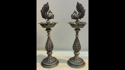 Prime Minister Narendra Modi gifts a silver lamp pair with Jhalar Work studded with precious stones to New Zealand PM Christopher Luxon, in Vientiane on Friday. Crafted from 92.5% silver, these lamps stand as a testament to the timeless elegance of Kolhapur's silver artistry, renowned for its intricate detailing and fine metalwork. Prime Minister Narendra Modi gifts a silver lamp pair with Jhalar Work studded with precious stones to New Zealand PM Christopher Luxon, in Vientiane on Friday. Crafted from 92.5% silver, these lamps stand as a testament to the timeless elegance of Kolhapur's silver artistry, renowned for its intricate detailing and fine metalwork.