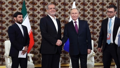 In this pool photograph distributed by the Russian state agency Sputnik, Russia's President Vladimir Putin meets with Iran's President Masoud Pezeshkian on the sidelines of an international forum "Interrelation of times and civilizations - basis of peace and development" dedicated to the 300th anniversary of poet Magtymguly Fragi's birthday in Ashgabat on October 11, 2024. (Photo by Alexander SHCHERBAK / POOL / AFP) (AFP) In this pool photograph distributed by the Russian state agency Sputnik, Russia's President Vladimir Putin meets with Iran's President Masoud Pezeshkian on the sidelines of an international forum "Interrelation of times and civilizations - basis of peace and development" dedicated to the 300th anniversary of poet Magtymguly Fragi's birthday in Ashgabat on October 11, 2024. (Photo by Alexander SHCHERBAK / POOL / AFP) (AFP)