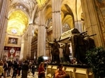 People visit the mausoleum of Christopher Columbus in the cathedral of Seville, Spain. 