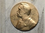 (FILES) This file photo taken on December 10, 2022, shows a plaque showing Swedish chemist, engineer, inventor, businessman, and philanthropist Alfred Nobel (1833-1896) on the podium during preparations ahead of the Nobel Prize award ceremony for literature, science and economy at the Concert Hall in Stockholm, Sweden. (Photo by Jonathan NACKSTRAND / AFP)