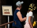 Voters walk towards a polling station to cast their ballots in early voting for the presidential election in Scottsdale, Arizona, U.S., October 10, 2024. 