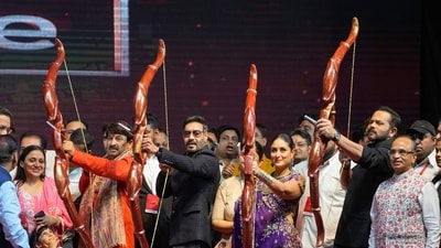 Actor Ajay Devgn and director Rohit Shetty twinned in black at the Dussehra festivities in Delhi. (PTI) Actor Ajay Devgn and director Rohit Shetty twinned in black at the Dussehra festivities in Delhi. (PTI)