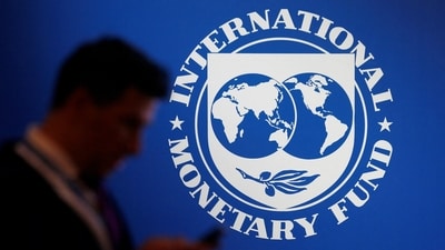 A participant stands near a logo of IMF at the International Monetary Fund-World Bank annual meeting at ,Bali, Indonesia. (Reuters)