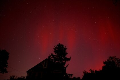 The Aurora borealis appears over a darkened neighborhood still without electricity nearly two weeks after Hurricane Helene (REUTERS)