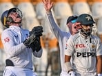 England's wicketkeeper Jamie Smith (L) takes a catch to dismiss Pakistan's Saud Shakeel (R). England's wicketkeeper Jamie Smith (L) takes a catch to dismiss Pakistan's Saud Shakeel (R).