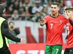 Cristiano Ronaldo protects a fan. Cristiano Ronaldo protects a fan.