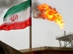 A gas flare on an oil production platform is seen alongside an Iranian flag in the Gulf.