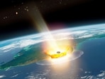 An artist's impression of a large asteroid impacting at Chicxulub on the Mexican coastline, which caused the end-Cretaceous mass extinction, 66 million years ago, with the planet Mars and asteroid bodies in the background.