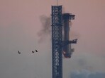 SpaceX's mega rocket booster returns to the launch pad to be captured during a test flight Sunday, Oct. 13, 2024, in Boca Chica,, Texas. (AP Photo/Eric Gay)
