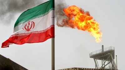 A gas flare on an oil production platform is seen alongside an Iranian flag in the Gulf. (REUTERS File)