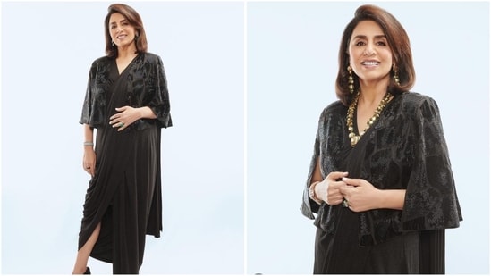 In another saree look, Neetu Kapoor shows how to slay black with style, donning a side-slit saree paired with an embellished blouse. She accessorised the look with a statement gold necklace and earrings, looking absolutely stunning.(Instagram/@neetu54)
