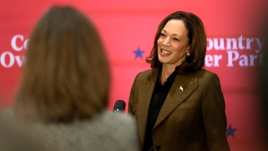 Kamala Harris has oriented her campaign around her economic proposals and criticism of Trump, rather than the possibility she’d make history with her election (AP)