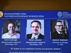The Nobel memorial prize in economics awarded to Daron Acemoglu, Simon Johnson and James A Robinson, seen on screen, during a press meeting at the Royal Swedish Academy of Sciences in Stockholm, Sweden, Monday Oct. 14, 2024.