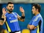 India's Virat Kohli talks with head coach Gautam Gambhir (R) during a practice session.