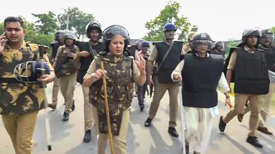 Bahraich: Police personnel during a flag march as tension escalates after violence during idol immersion yesterday, in Bahraich on Monday (PTI) Bahraich: Police personnel during a flag march as tension escalates after violence during idol immersion yesterday, in Bahraich on Monday (PTI)