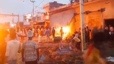 People set fire to two-wheelers after a man died of a gunshot wound during a religious procession carrying an idol of Goddess Durga for immersion at Mahrajganj Bazar in Bahraich. (PTI) People set fire to two-wheelers after a man died of a gunshot wound during a religious procession carrying an idol of Goddess Durga for immersion at Mahrajganj Bazar in Bahraich. (PTI)