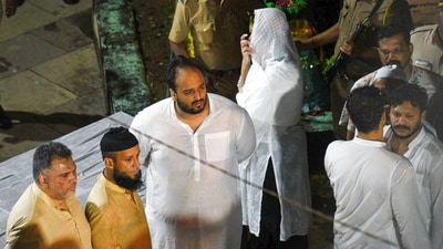 Congress MLA Zeeshan Siddiqui (center in white) and others during the last rites of former Maharashtra minister Baba Siddique at Bada Qabrastan in Mumbai on October 13. (PTI) Congress MLA Zeeshan Siddiqui (center in white) and others during the last rites of former Maharashtra minister Baba Siddique at Bada Qabrastan in Mumbai on October 13. (PTI)