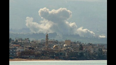 TOPSHOT - This picture taken from the southern Lebanese city of Tyre shows smoke billowing after an Israeli airstrike that targeted the southern Lebanese village of Qlaileh, on October 14, 2024, amid the ongoing war between Israel and Hezbollah. (Photo by Kawnat HAJU / AFP) (AFP)