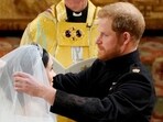 FILE PHOTO: Prince Harry and Meghan Markle in St George's Chapel at Windsor Castle during their wedding service, conducted by the Archbishop of Canterbury Justin Welby in Windsor, Britain, May 19, 2018. Owen Humphreys/Pool via REUTERS/File Photo